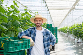 stock-photo-smiling-farmer-standing-plastic-box