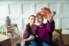 young-couple-moving-into-new-home_23-2149199065